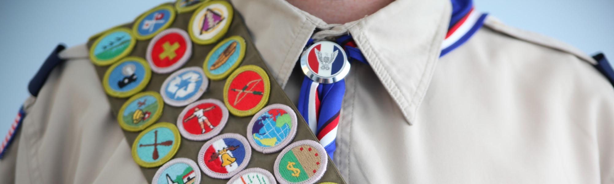 image of a scout with a sash of badges