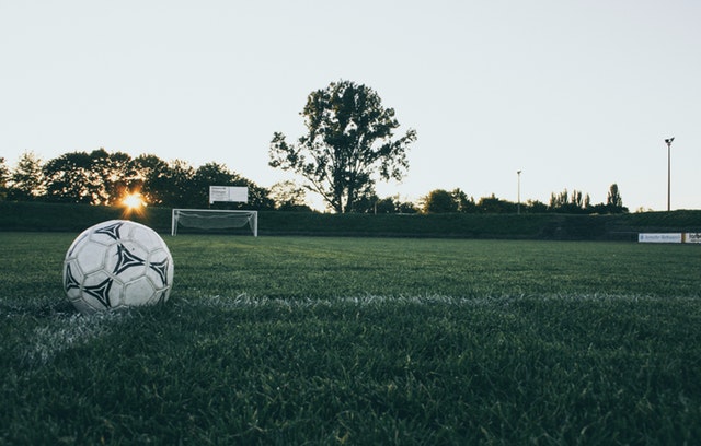 image of soccer field with a soccer ball off to the side
